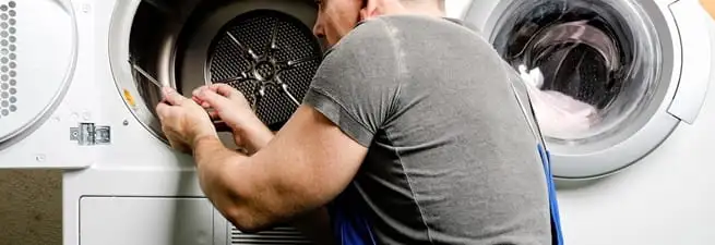 Dryer repair technician fixing a clothes dryer drum in Salt Lake City, UT