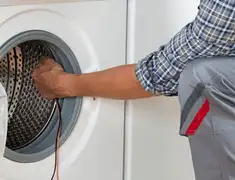 Dryer repair technician diagnosing and servicing a clothes dryer in Salt Lake City, UT