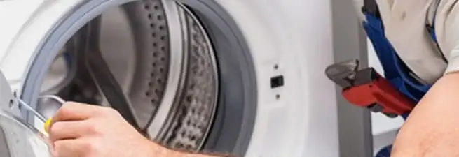 Appliance technician repairing a clothes dryer drum and internal parts in Salt Lake City, UT