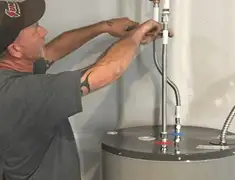 Water heater repair technician tightening supply line connections in Salt Lake City, UT